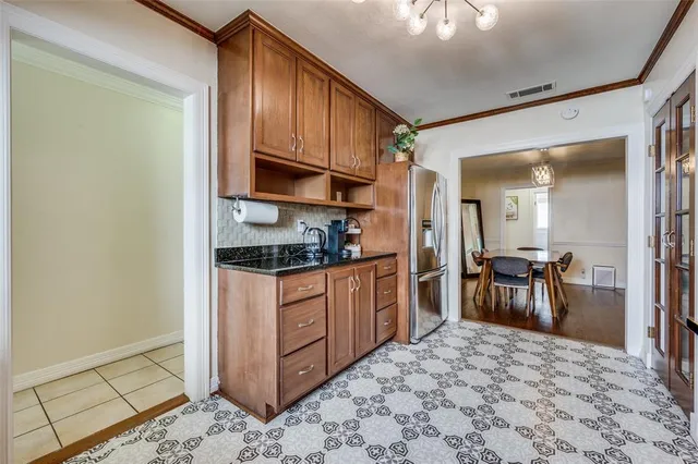 a kitchen with stainless steel appliances granite countertop a refrigerator stove top oven and sink