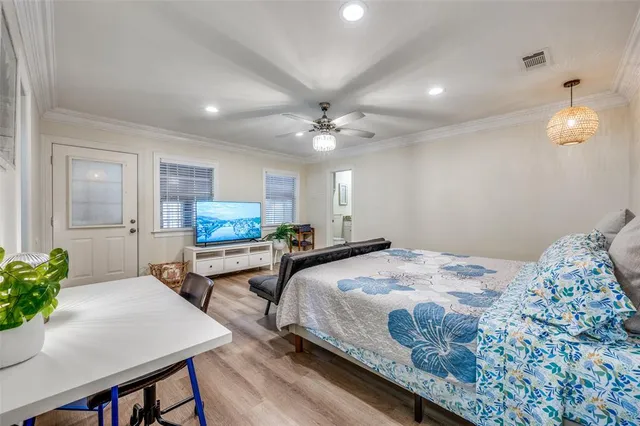 a bedroom with a bed and a chandelier