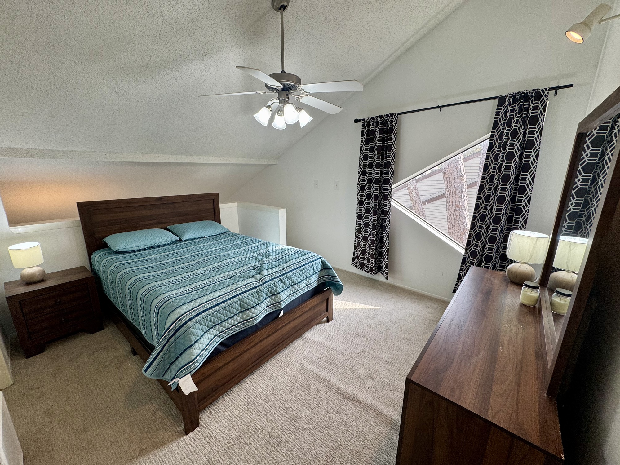 12900 Walden Road, Unit 820 Montgomery, TX 77356 - Photo 12 of 14 a bedroom with a bed and dresser with wooden floor