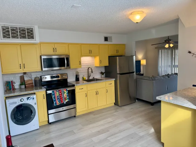 a kitchen with refrigerator and microwave