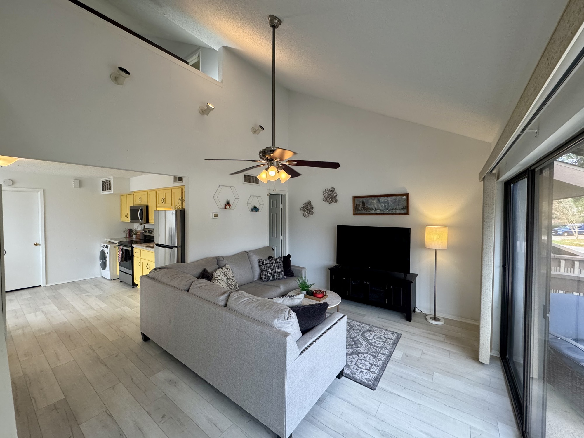 12900 Walden Road, Unit 820 Montgomery, TX 77356 - Photo 6 of 14 a living room with furniture a fireplace and a chandelier