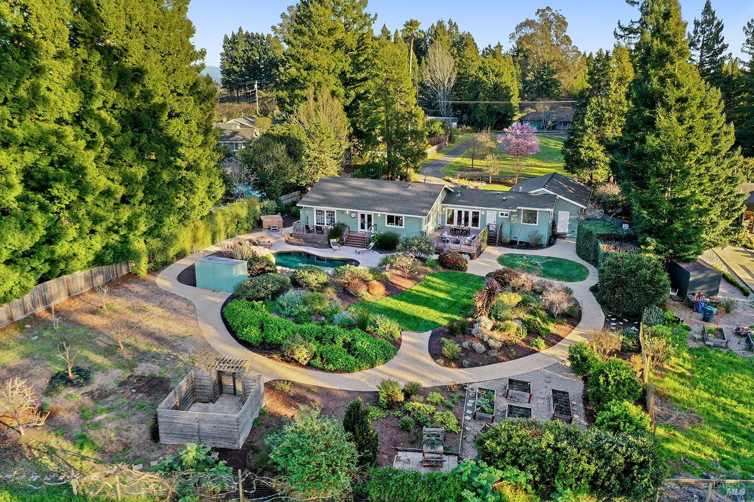 an aerial view of a house with a garden and swimming pool