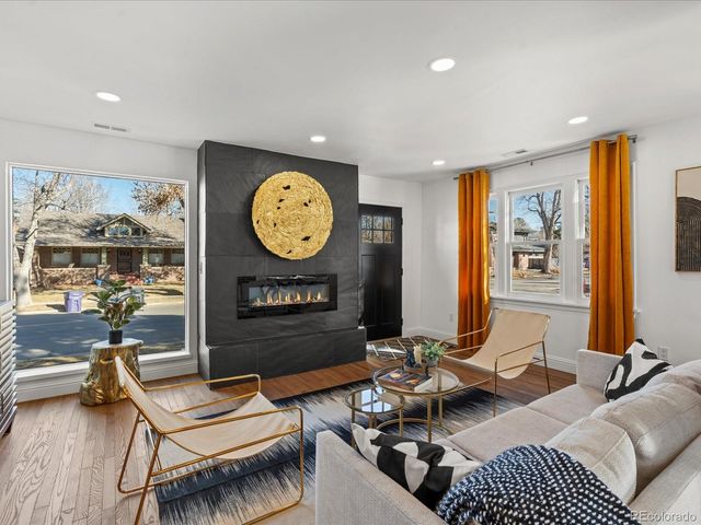 a living room with furniture a rug and a window