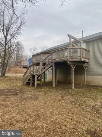 a view of a house with a wooden deck