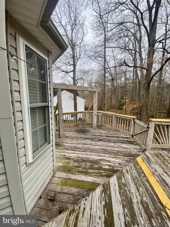 a view of a balcony with two chairs and wooden floor