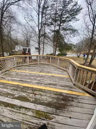 a view of swimming pool with deck and trees