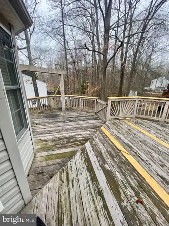 a view of balcony with wooden floor and fence