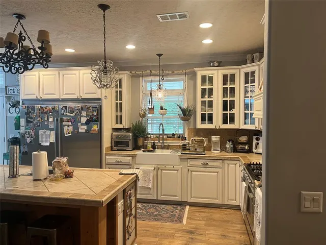 a kitchen with lots of counter top space and wooden floor