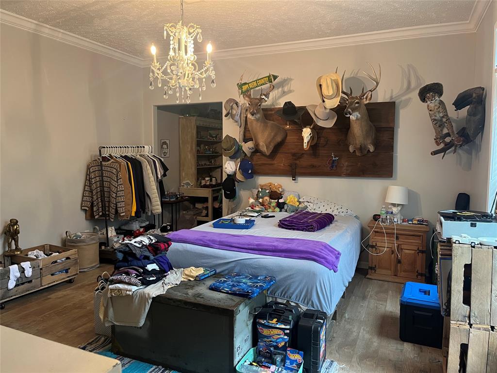 2080 Highway 162 Benton, LA 71006 - Photo 5 of 19 a bedroom with bed and a chandelier