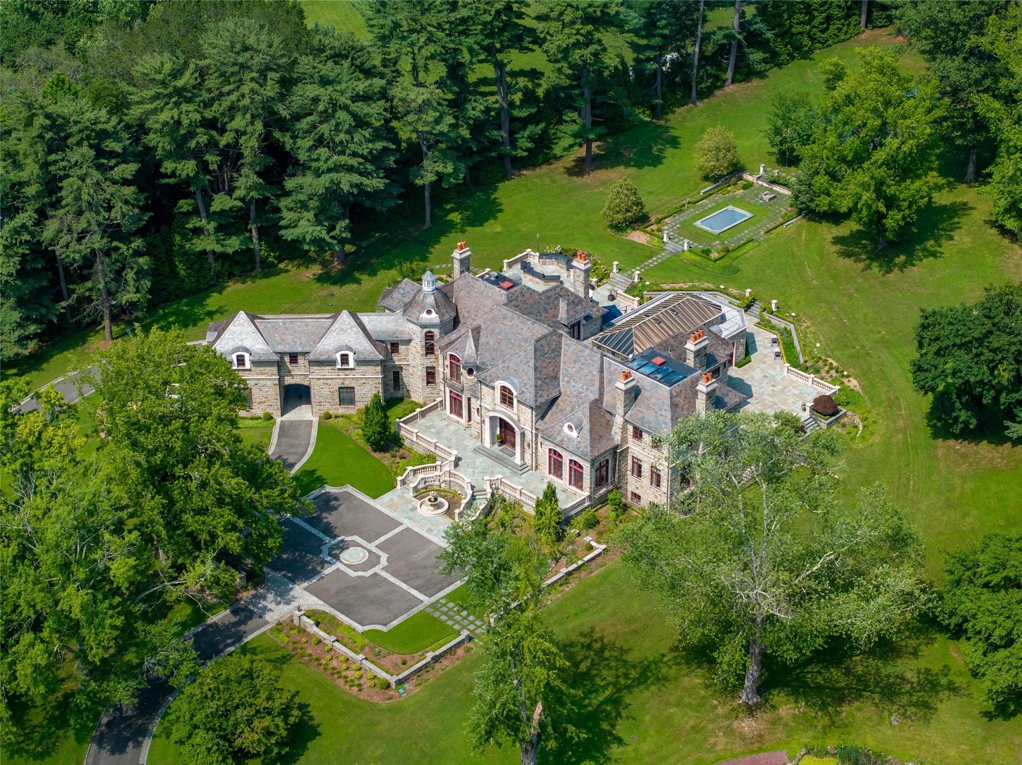 an aerial view of residential house with outdoor space and swimming pool