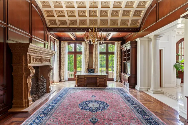 a living room with furniture fireplace and rug