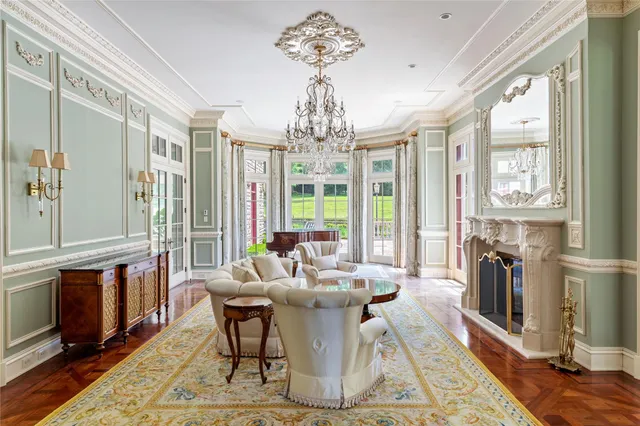 a dining room with furniture a chandelier and wooden floor