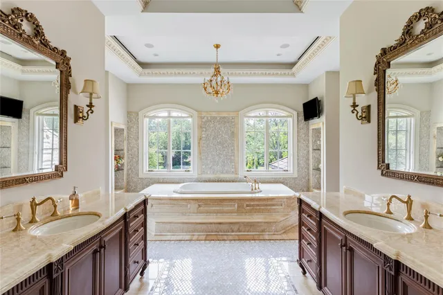 a spacious bathroom with a granite countertop tub sink and mirror