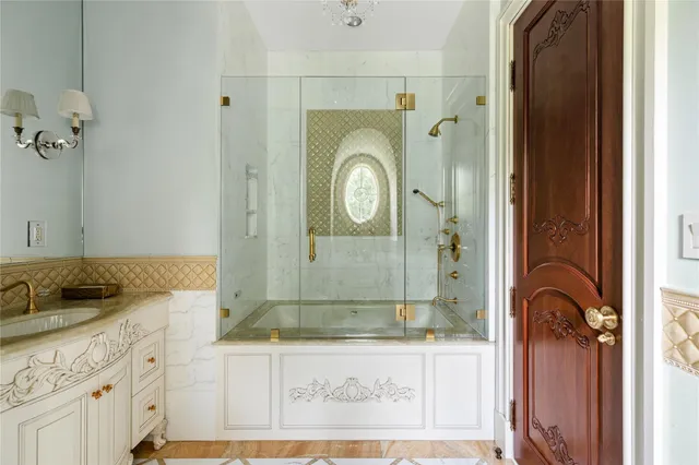 a bathroom with a granite countertop sink mirror and shower