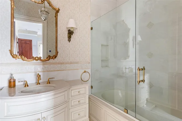 a bathroom with a shower sink and mirror