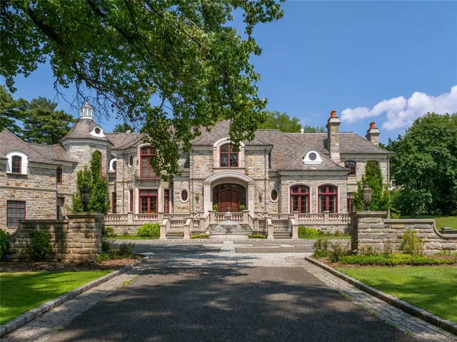 a front view of a house with a garden and plants