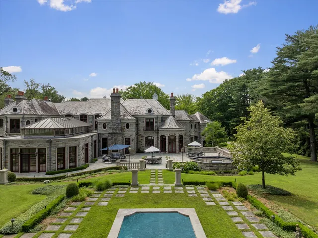 a view of a house with swimming pool yard and outdoor seating