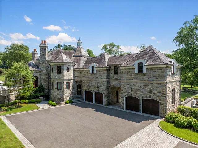 a front view of a house with a garden and plants