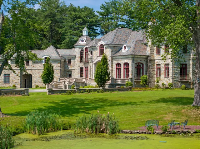 a front view of house with yard and green space