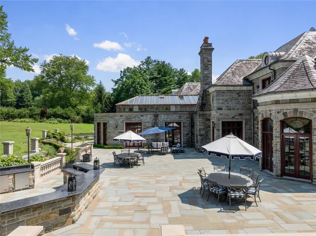 a patio with a table and chairs under an umbrella