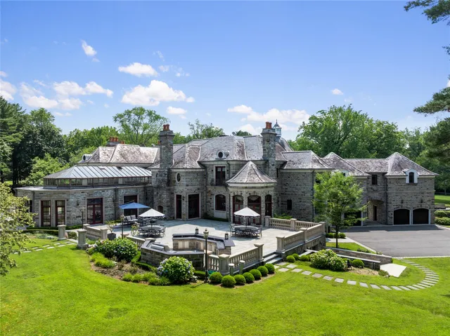 a front view of a house with swimming pool and a yard