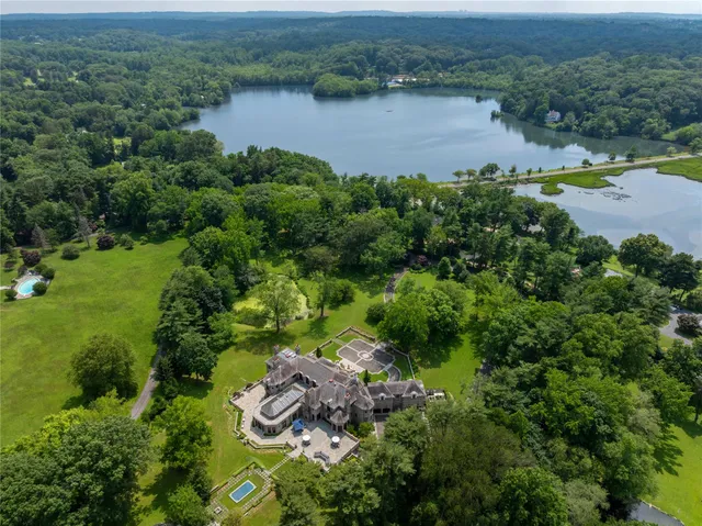 an aerial view of a houses with a lake view