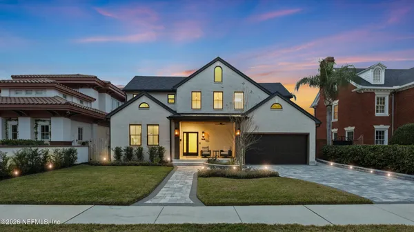 a front view of a house with a yard and outdoor seating
