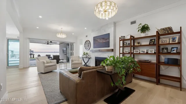 a living room with furniture and a chandelier