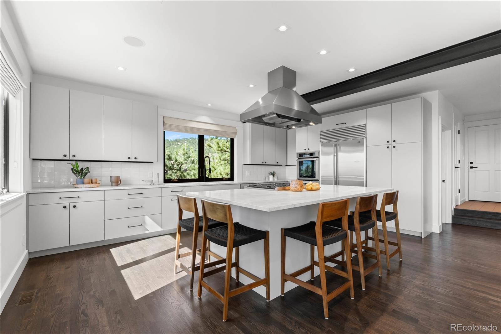 14 Pine Brook Road Boulder, CO 80304 - Photo 13 of 49 a kitchen with a table chairs wooden floors and white stainless steel appliances