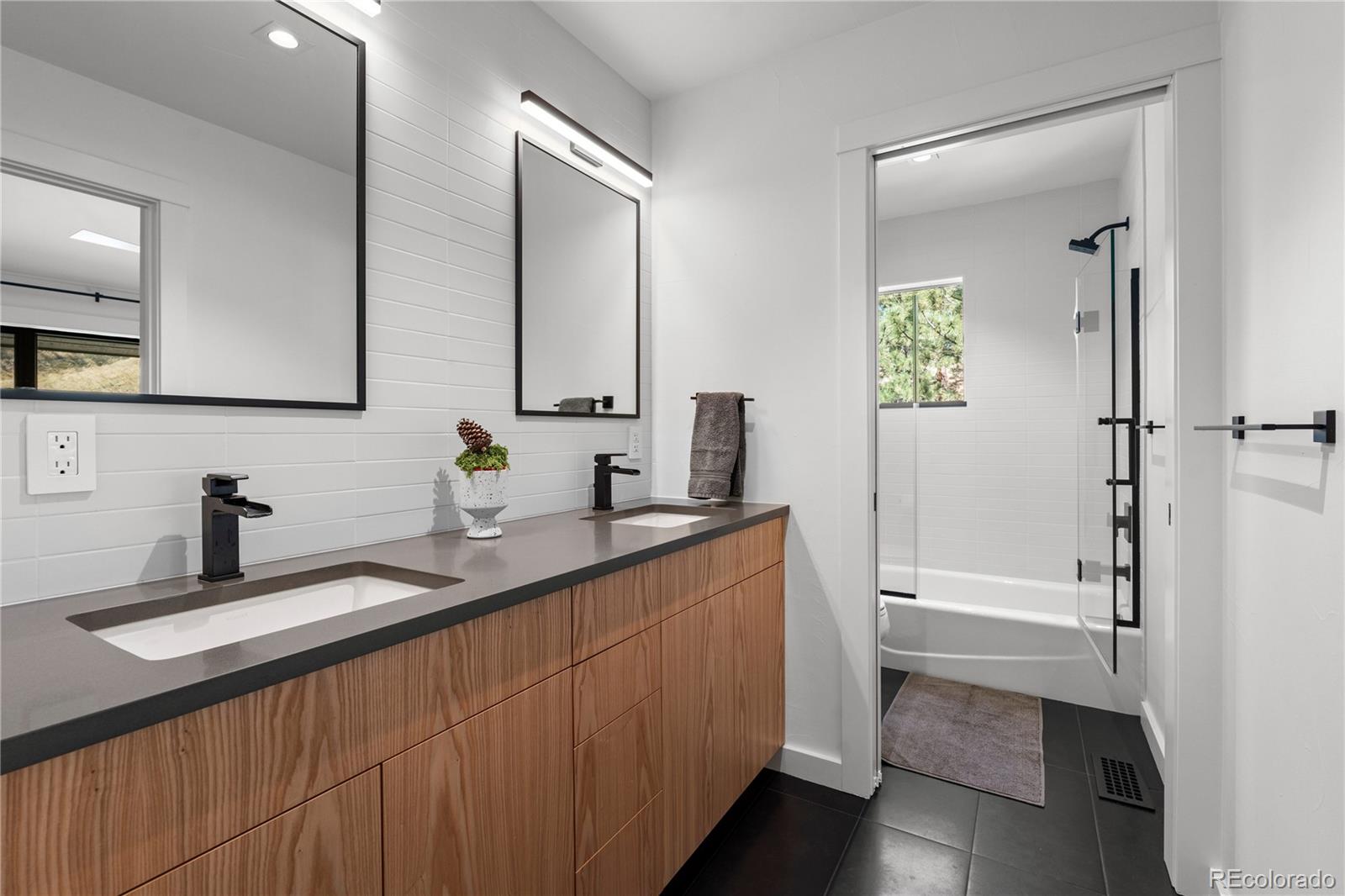 14 Pine Brook Road Boulder, CO 80304 - Photo 32 of 49 a bathroom with a double vanity sink and a mirror
