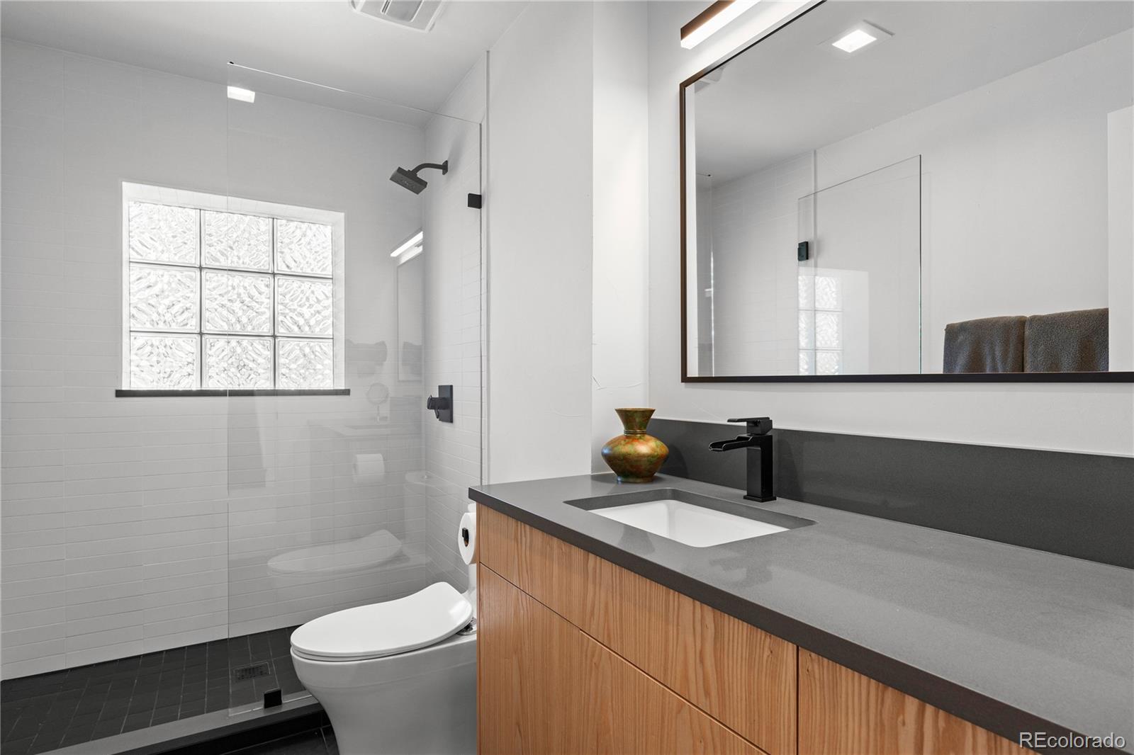 14 Pine Brook Road Boulder, CO 80304 - Photo 39 of 49 a bathroom with a double vanity sink toilet and a mirror