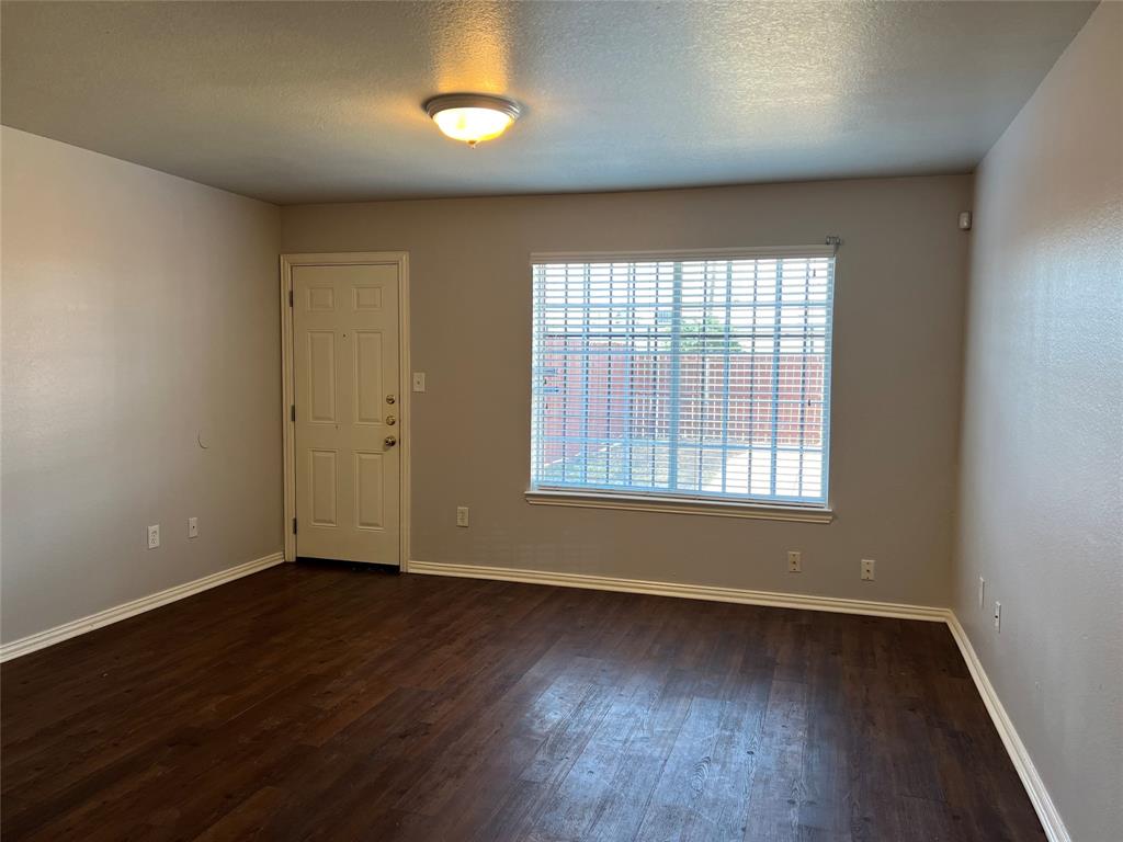 4027 Preferred Place Dallas, TX 75237 - Photo 11 of 27 an empty room with wooden floor and windows