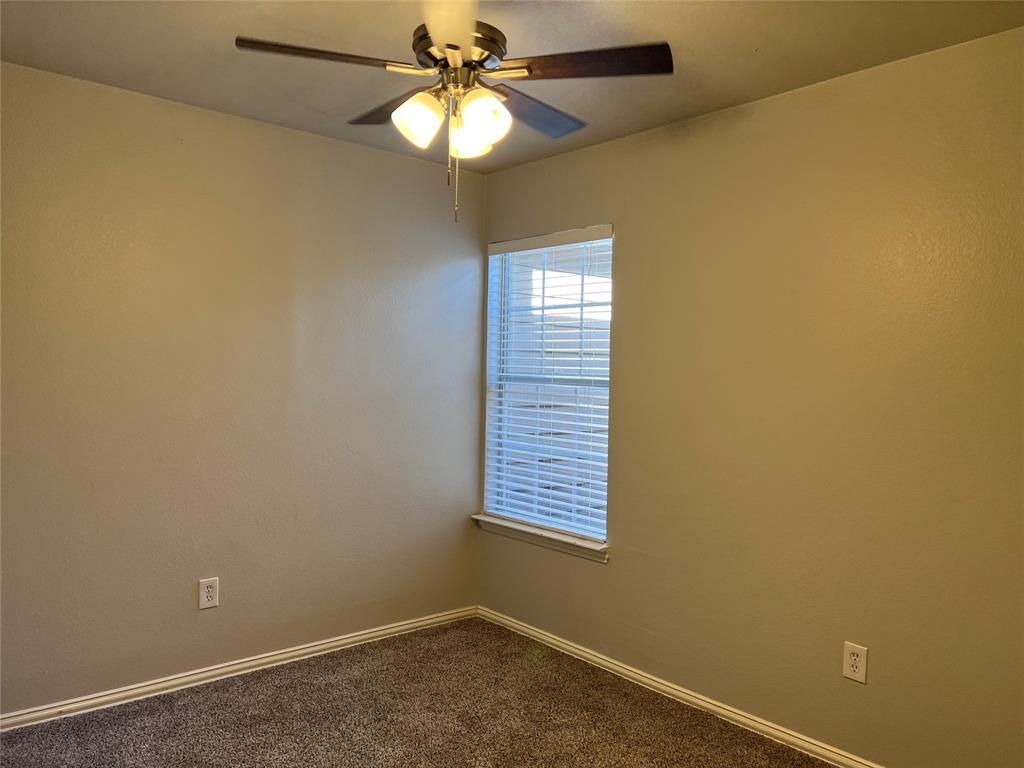 4027 Preferred Place Dallas, TX 75237 - Photo 17 of 27 an empty room with a window and a fan