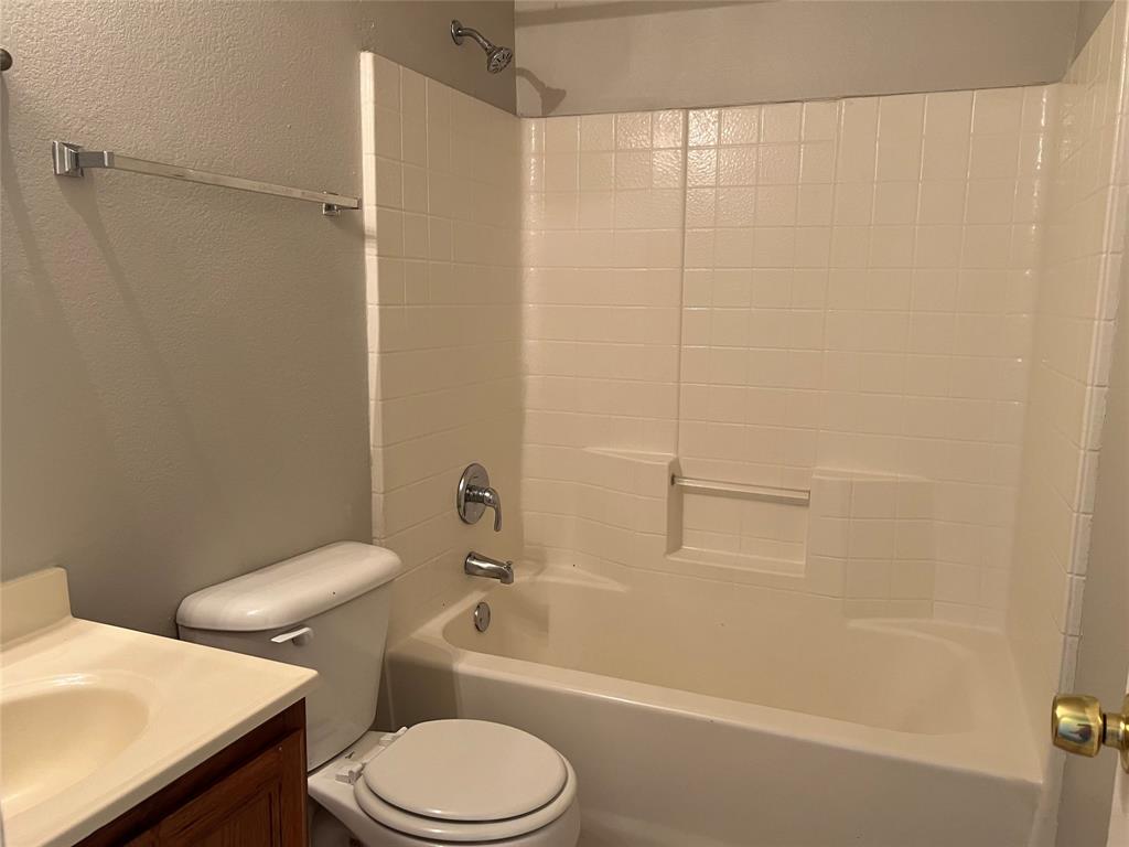 4027 Preferred Place Dallas, TX 75237 - Photo 21 of 27 a white toilet sitting next to a bath tub