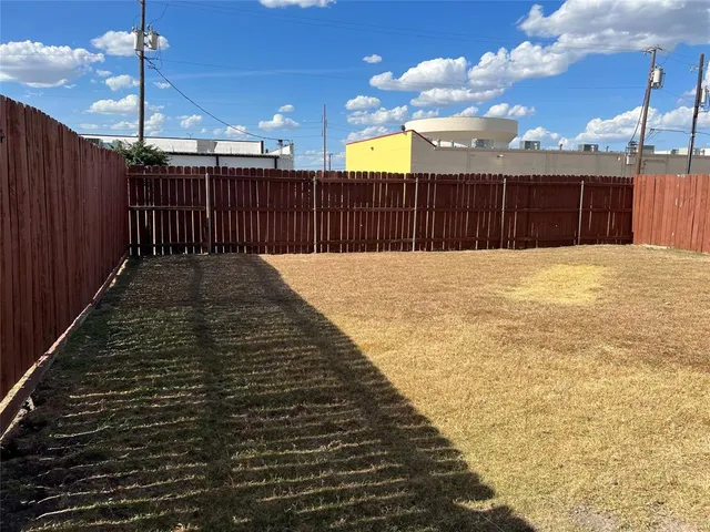 a view of a brick house with a yard
