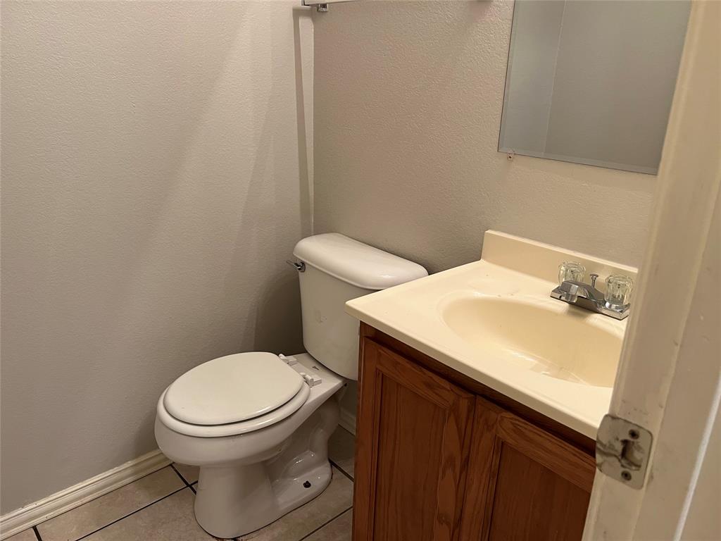 4027 Preferred Place Dallas, TX 75237 - Photo 6 of 27 a bathroom with a sink and a toilet
