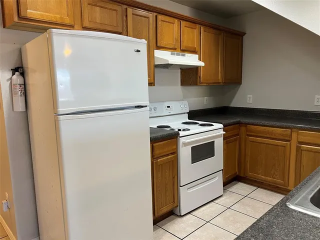 a white refrigerator freezer sitting inside of a kitchen