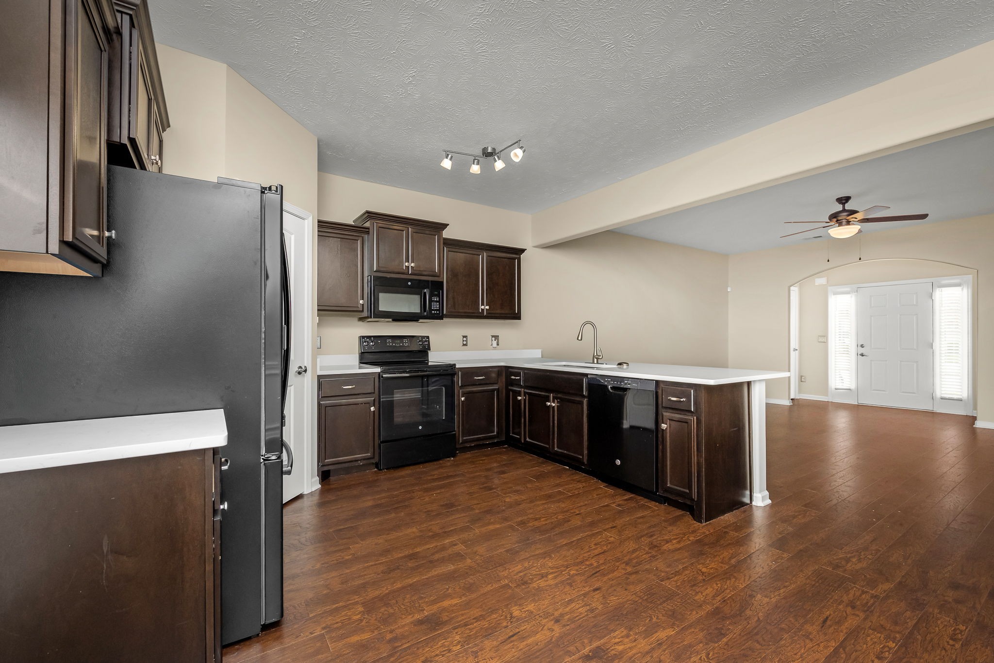 5322 Dan Post Way Murfreesboro, TN 37128 - Photo 18 of 39 a kitchen with stainless steel appliances kitchen island granite countertop a refrigerator a sink dishwasher a stove with wooden cabinets and wooden floor
