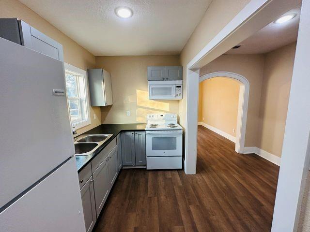 1423 East Elm Street Tyler, TX 75702 - Photo 11 of 15 a kitchen with granite countertop a stove and wooden floor