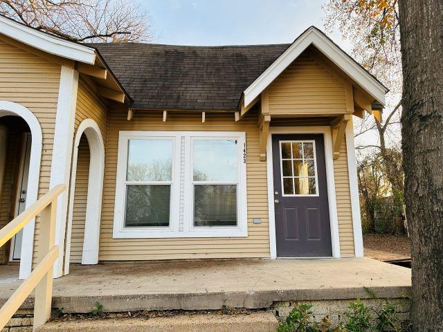 1423 East Elm Street Tyler, TX 75702 - Photo 2 of 15 a front view of a house with a yard