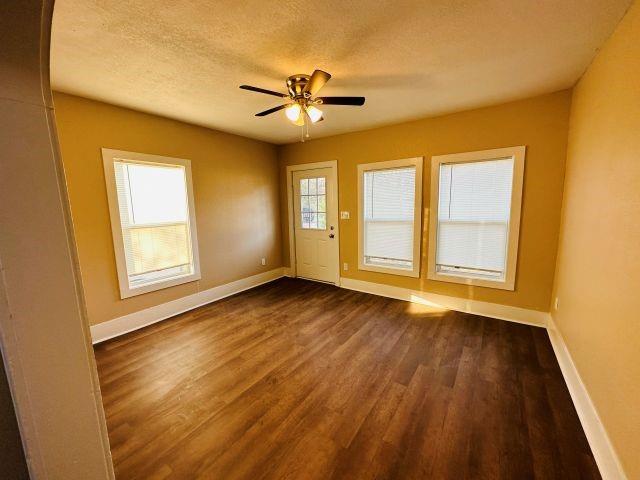 1423 East Elm Street Tyler, TX 75702 - Photo 4 of 15 a view of an empty room with wooden floor and a window