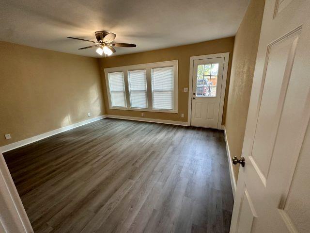 1423 East Elm Street Tyler, TX 75702 - Photo 5 of 15 a view of an empty room with wooden floor and a window