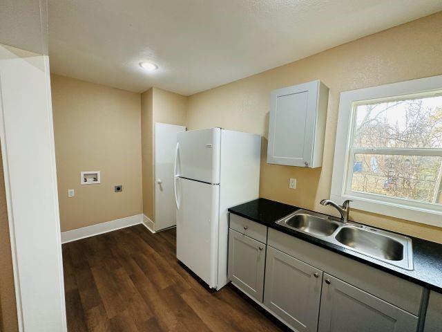 1423 East Elm Street Tyler, TX 75702 - Photo 10 of 15 a kitchen with a sink and a refrigerator