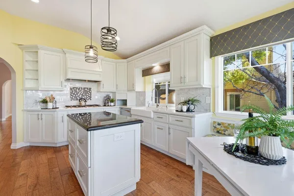 a kitchen with a sink stove and cabinets