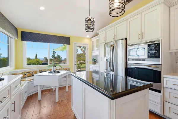 a kitchen with stainless steel appliances granite countertop a sink a stove and a refrigerator