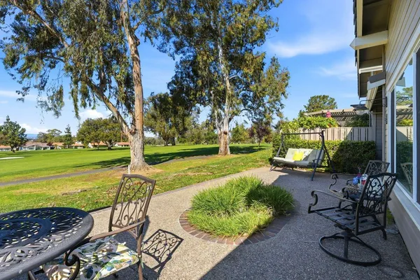 a view of a backyard with sitting area