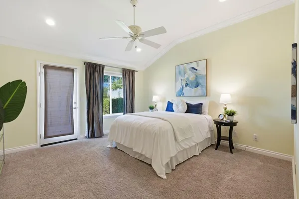 a bedroom with a bed and painting on the wall