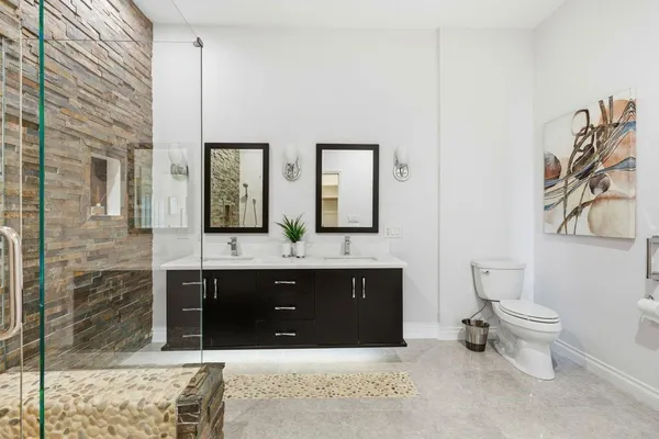 a spacious bathroom with a bathtub and a double vanity sink