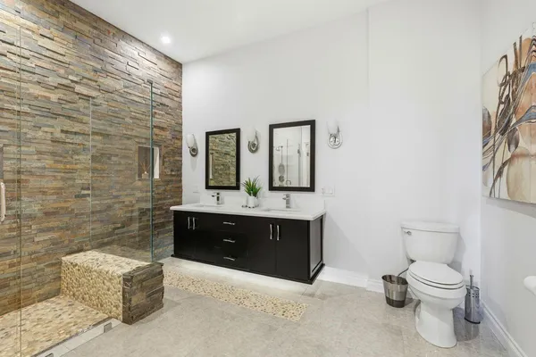 a spacious bathroom with a toilet sink and mirror