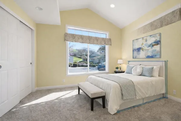 a bedroom with a bed and a painting on the wall